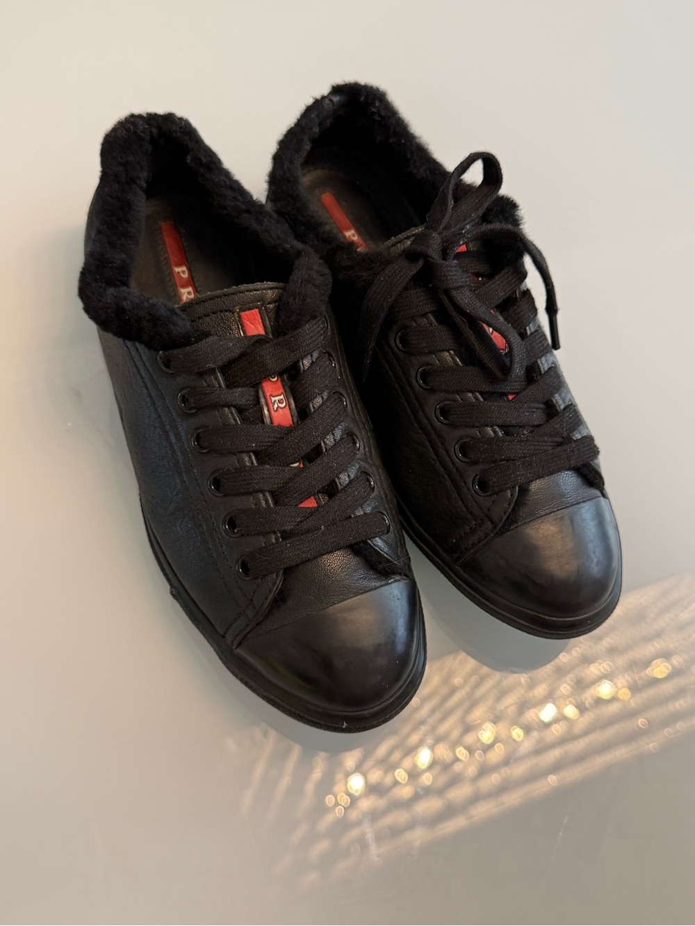 Prada Black Leather Fur-Lined Sneakers